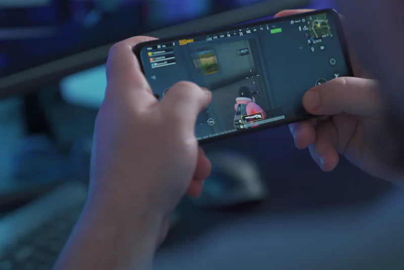 Close-up of hands holding a smartphone during a mobile game